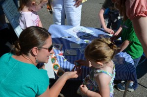 Tina Masciarelli, Buy Haywood Project Coordinator, and a Kids Corner participant. This little lady scored an ASAP I tried local greens sticker for sampling a Broc Calzone