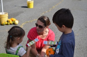 Tina Masciarelli, Buy Haywood Project Coordinator, sharing WNC Healthy Kids' 5-2-1 Almost None information at a Kids Corner event at Waynesville's Original Tailgate Mkt